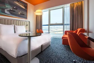 a hotel room with a bed and a table and a chair at Park Inn by Radisson Dubai Motor City in Dubai