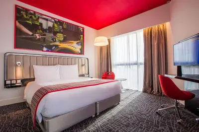 a hotel room with a bed and a flat screen tv at Park Inn by Radisson Dubai Motor City in Dubai