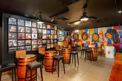 a restaurant with tables and stools in a room at Citymax Hotel Al Barsha at the Mall in Dubai