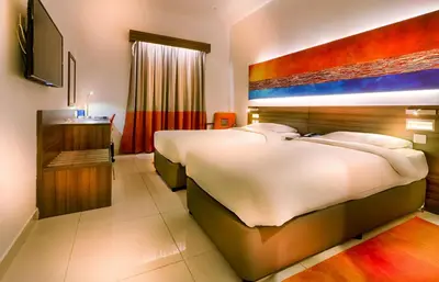 a hotel room with two beds and a television at Citymax Hotel Al Barsha at the Mall in Dubai