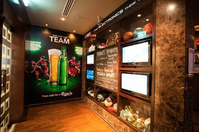 a restaurant with a team sign on the wall at Citymax Hotel Al Barsha at the Mall in Dubai