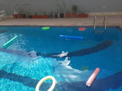 a swimming pool with a bunch of frisbees in it at Al Raya Hotel Apartments in Dubai