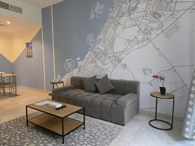 a living room with a couch and a map on the wall at Al Raya Hotel Apartments in Dubai