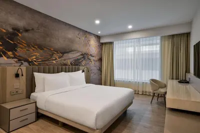 a hotel room with a bed and a desk at Residence Inn by Marriott Sheikh Zayed Road, Dubai in Dubai