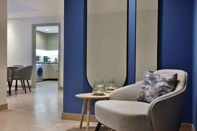 a living room with a chair and a table at Residence Inn by Marriott Sheikh Zayed Road, Dubai in Dubai