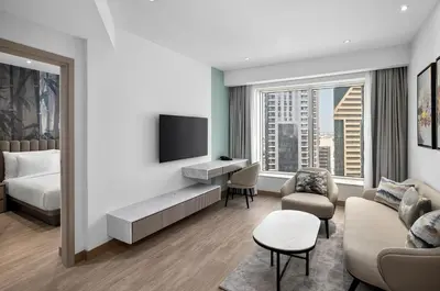 a hotel room with a bed and a tv at Residence Inn by Marriott Sheikh Zayed Road, Dubai in Dubai