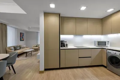 a kitchen and living room with a washer and dryer at Residence Inn by Marriott Sheikh Zayed Road, Dubai in Dubai