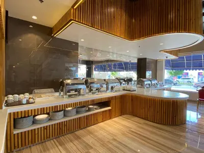 a kitchen with a counter with plates on it at Baity Hotel Apartments in Dubai