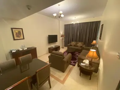 a living room with a couch and a table at Baity Hotel Apartments in Dubai