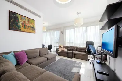 a living room with a couch and a flat screen tv at New Arabian Burj Residence 1 & 8 Downtown Dubai in Dubai