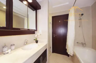 a bathroom with a sink and a tub and a mirror at New Arabian Burj Residence 1 & 8 Downtown Dubai in Dubai