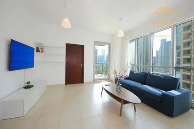 a living room with a blue couch and a table at New Arabian Burj Residence 1 & 8 Downtown Dubai in Dubai