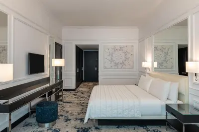 a bedroom with a bed and a flat screen tv at Le Meridien Mina Seyahi Beach Resort & Waterpark in Dubai