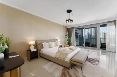 a bedroom with a bed and a large window at Maison Privee - Ultimate Living with Front-Row Views of Burj Khalifa & Dubai Fountains in Dubai