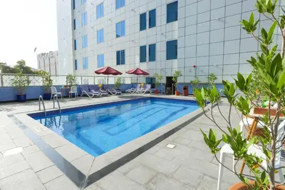 a swimming pool in front of a building at Omega Hotel Dubai in Dubai