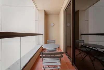 a table and two stools in a room at Maison Privee - Premium Apt in the Heart of JBR Beach, Dubai in Dubai