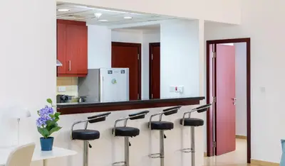 a row of stools in a kitchen with a mirror at Maison Privee - Premium Apt in the Heart of JBR Beach, Dubai in Dubai