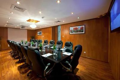 a conference room with a long table and chairs at Rolla Residence Hotel Apartment in Dubai