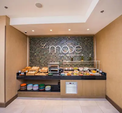 a buffet line with food in a restaurant at MENA Plaza Hotel Albarsha At The Mall in Dubai