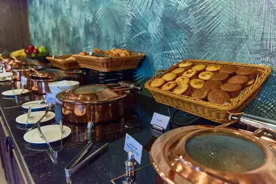 a buffet of cookies and pastries on a table at Rose Park Hotel - Al Barsha, Opposite Metro Station in Dubai