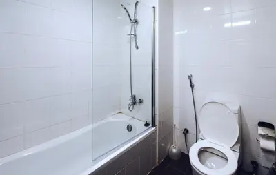 a white bathroom with a toilet and a shower at Near Burj Khalifa, DownTown - Burj Al Nujoom in Dubai