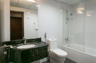 a bathroom with a sink and a toilet and a shower at Near Burj Khalifa, DownTown - Burj Al Nujoom in Dubai