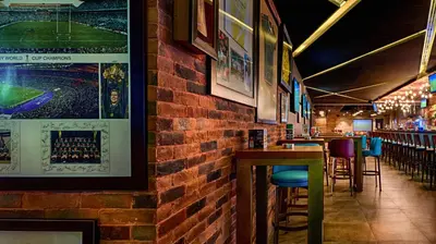a bar with a brick wall and some stools at Citymax Hotel Bur Dubai in Dubai