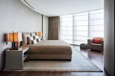 a bedroom with a large bed and a couch at Armani Hotel Dubai, Burj Khalifa in Dubai