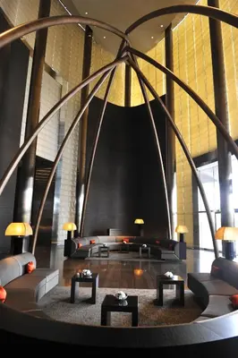 a lobby with couches and tables in a building at Armani Hotel Dubai, Burj Khalifa in Dubai