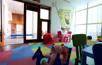 a teddy bear sitting on a chair in a room at voco - Bonnington Dubai by IHG in Dubai