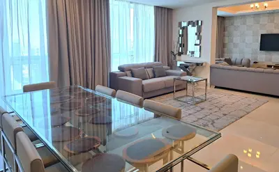 a living room with a glass table and chairs at Barceló Residences Dubai Marina in Dubai