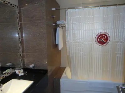 a bathroom with a shower with a toilet and a sink at Ramee Rose Hotel in Dubai