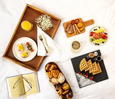 a table with breakfast foods and a plate of food at Jumeirah Zabeel Saray Dubai in Dubai