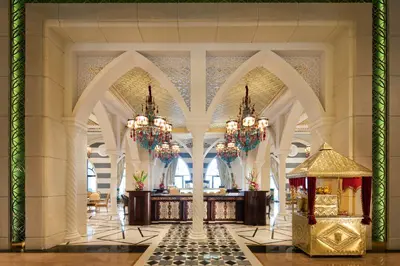 a lobby of a hotel with chandeliers at Jumeirah Zabeel Saray Dubai in Dubai