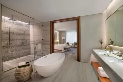 a bathroom with a large white tub and a shower at The St. Regis Downtown Dubai in Dubai