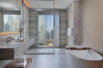 a bathroom with a tub and a view of a city at The St. Regis Downtown Dubai in Dubai