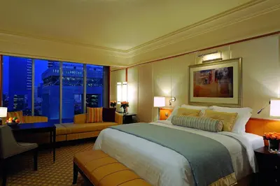 a bedroom with a large bed and a large window at Ritz Carlton DIFC Downtown Dubai in Dubai