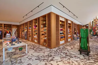 a dressing room with wooden cabinets and a marble floor at Bvlgari Resort Dubai in Dubai