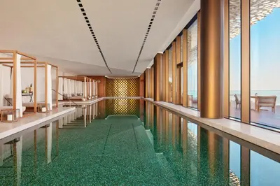 a swimming pool with a floor of water in a building at Bvlgari Resort Dubai in Dubai