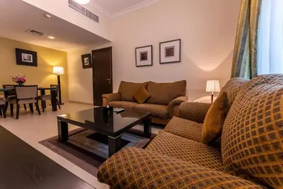 a living room with a couch and a table at Gulf Oasis Hotel Apartments Fz LLC in Dubai