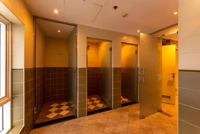 a row of stalls in a public restroom with stallsktop at Gulf Oasis Hotel Apartments Fz LLC in Dubai