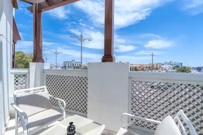 a balcony with white chairs and a view of the city at Beach Walk Boutique Jumeirah in Dubai