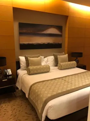 a bedroom with a large bed with a painting on the wall at Address Dubai Mall Fashion Avenue 1 bedroom 23 floor in Dubai