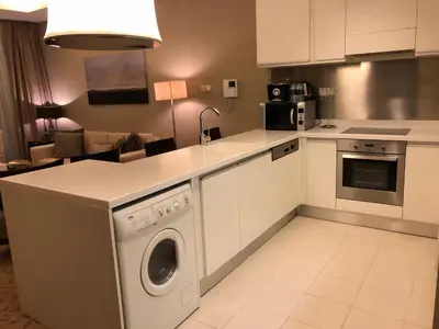 a kitchen with a washer and dryer in it at Address Dubai Mall Fashion Avenue 1 bedroom 23 floor in Dubai