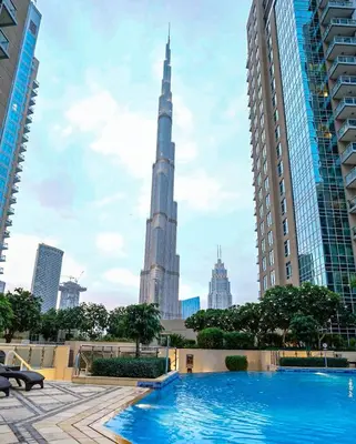a view of the burj khalifa from the pool in the city at Elite Royal Apartment - Full Burj Khalifa & Fountain view - Opal - 2 bedrooms plus 1 open bedroom without partition in Dubai