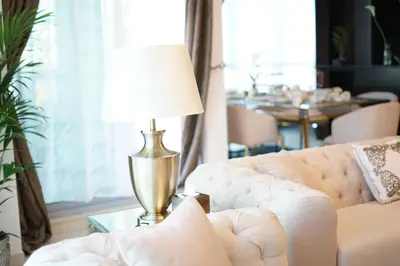 a living room with a couch and a lamp on a table at Elite Royal Apartment - Full Burj Khalifa & Fountain view - Opal - 2 bedrooms plus 1 open bedroom without partition in Dubai