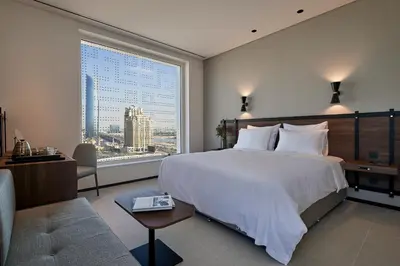 a bedroom with a large bed and a large window at FORM Hotel Al Jaddaf, Dubai, a Member of Design Hotels in Dubai