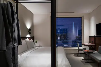 a hotel room with a bed and a view of a city at FORM Hotel Al Jaddaf, Dubai, a Member of Design Hotels in Dubai