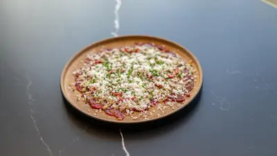 a pizza sitting on top of a table at FORM Hotel Al Jaddaf, Dubai, a Member of Design Hotels in Dubai