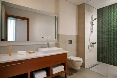 a bathroom with a sink and a toilet and a shower at Element Me'aisam, Dubai in Dubai